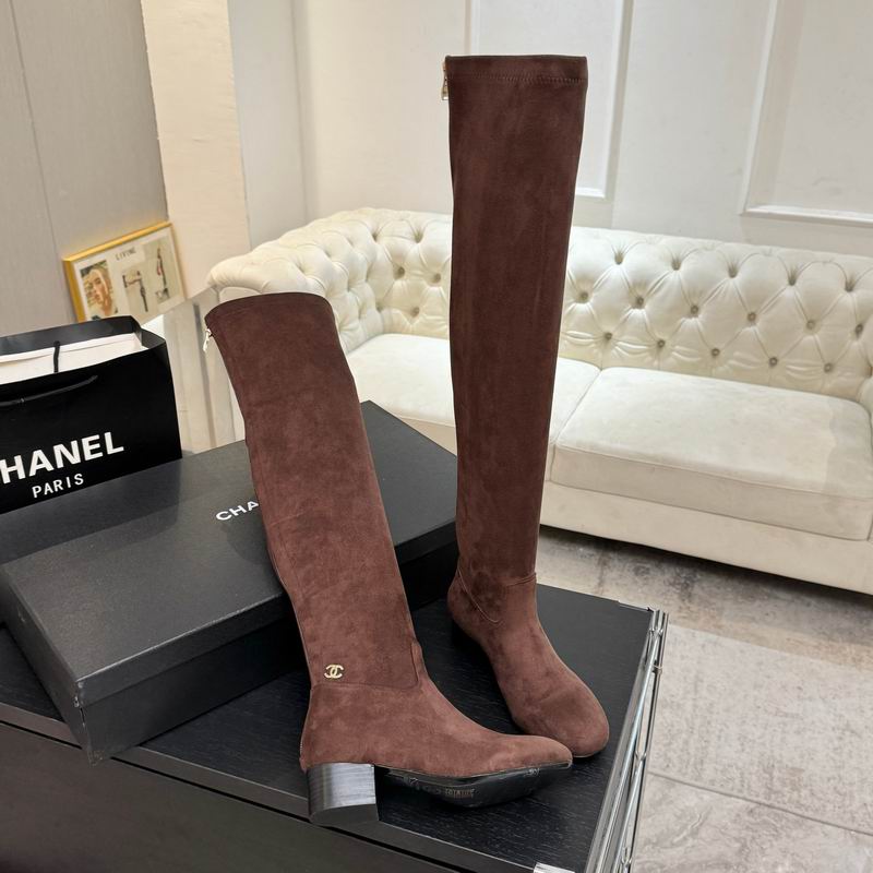 Chocolate brown over-the-knee stretch suede boots with gold-tone logo hardware and back zip, displayed on branded box